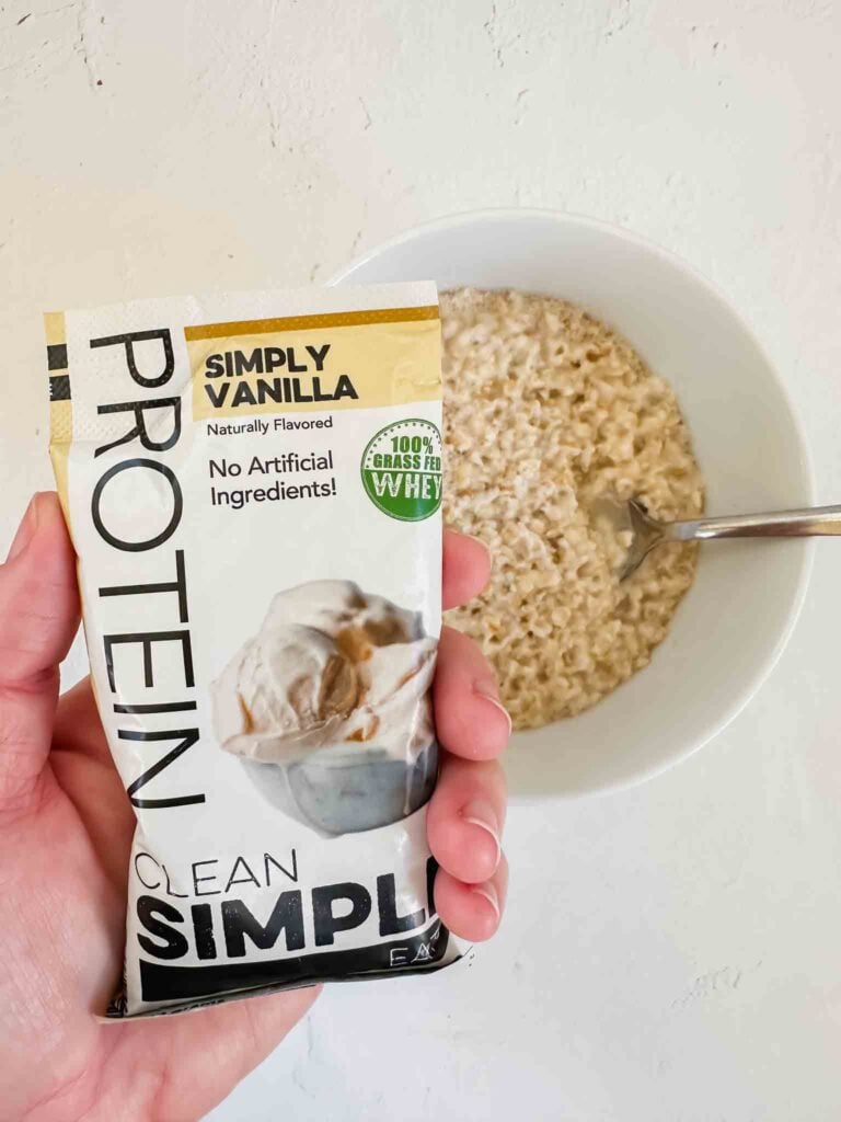 Protein powder package over bowl of oatmeal