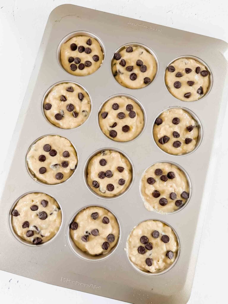 Overhead of muffin tin with pancake mix muffin batter