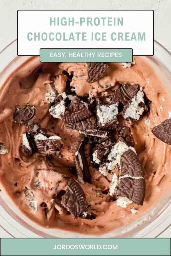 This is a picture of chocolate protein ice cream pinterest pin. There's a creami base with smooth, creamy chocolate ice cream topped with crushed oreo cookie pieces.