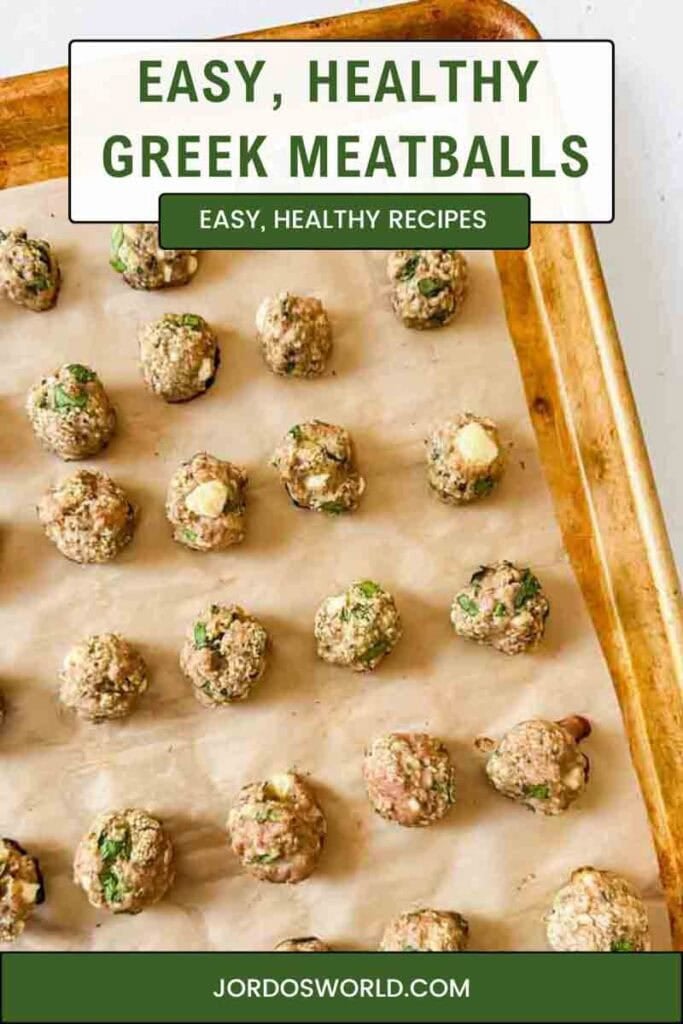 This is a pinterest pin of greek meatballs. There's a baking sheet with parchment paper and baked greek meatballs on top. The meatballs have spinach, feta, and are light brown.